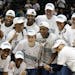 Members of the Minnesota Lynx hold the championship trophy, center, after defeating the Atlanta Dream 73-67 to complete a three-game sweep of the WNBA
