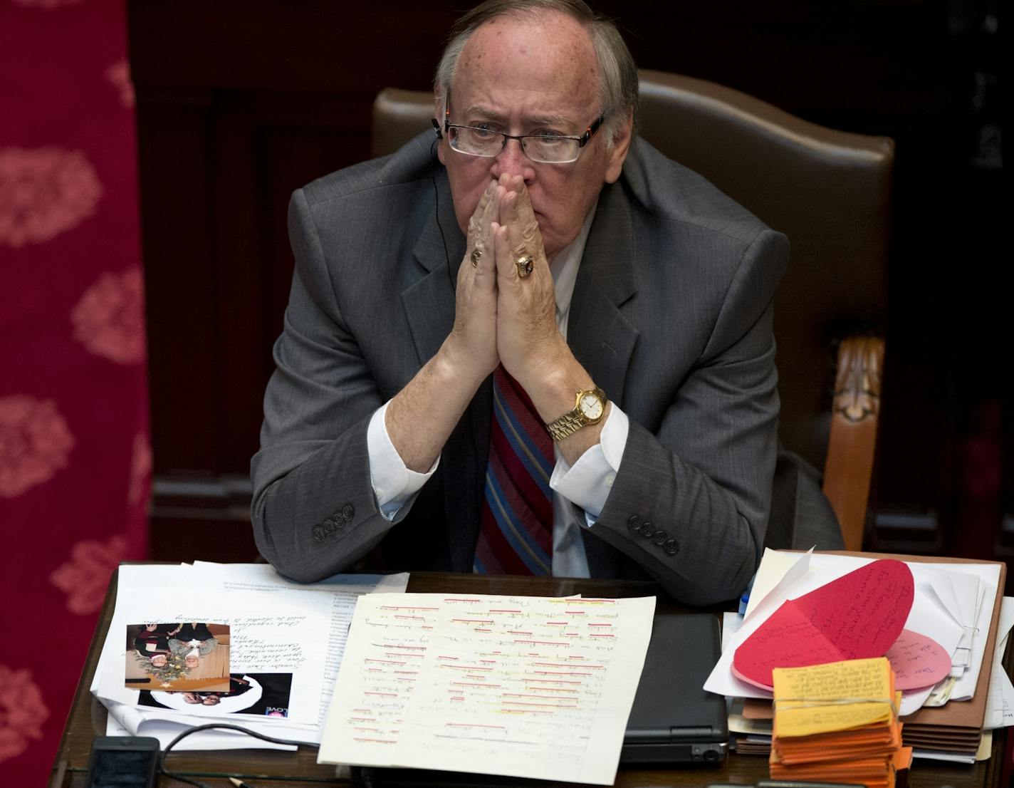 Sen David Senjem listened to the floor debate, his desk covered with letters and pictures from advocates from both sides of the issue. Monday, May 13, 2013