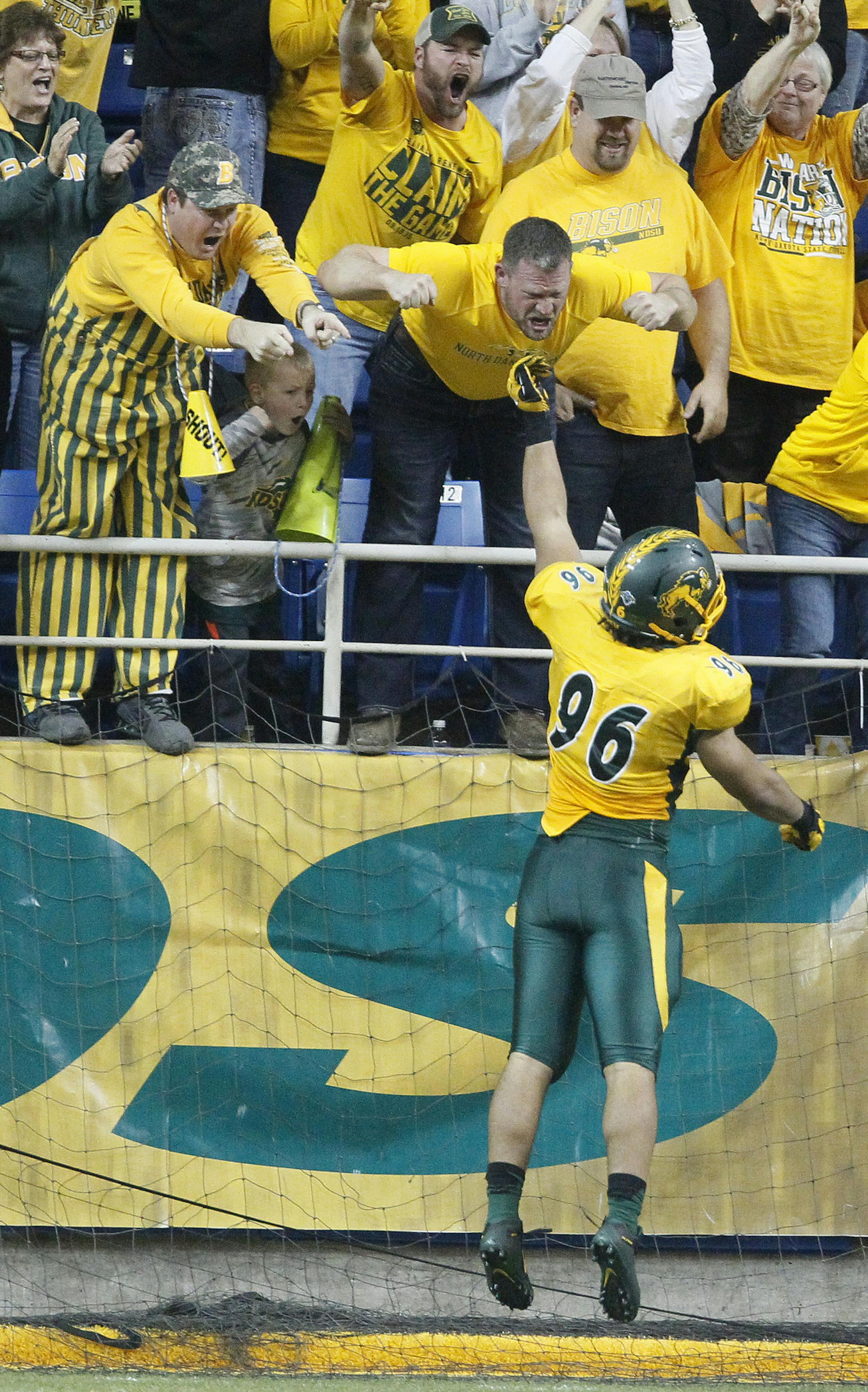North Dakota State's Greg Menard celebrates a safety with fans in the second half against Northern Iowa iin an NCAA college football game in the quarterfinals of the Football Championship Subdivision at the FargoDome Saturday, Dec. 12, 2015, in Fargo, N.D. (Matthew Putney/The Courier via AP) MANDATORY CREDIT