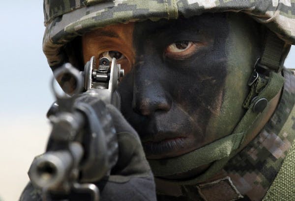 FILE - In this April 26, 2013 file photo, a South Korean Marine takes position during the joint military exercises between South Korea and the United 