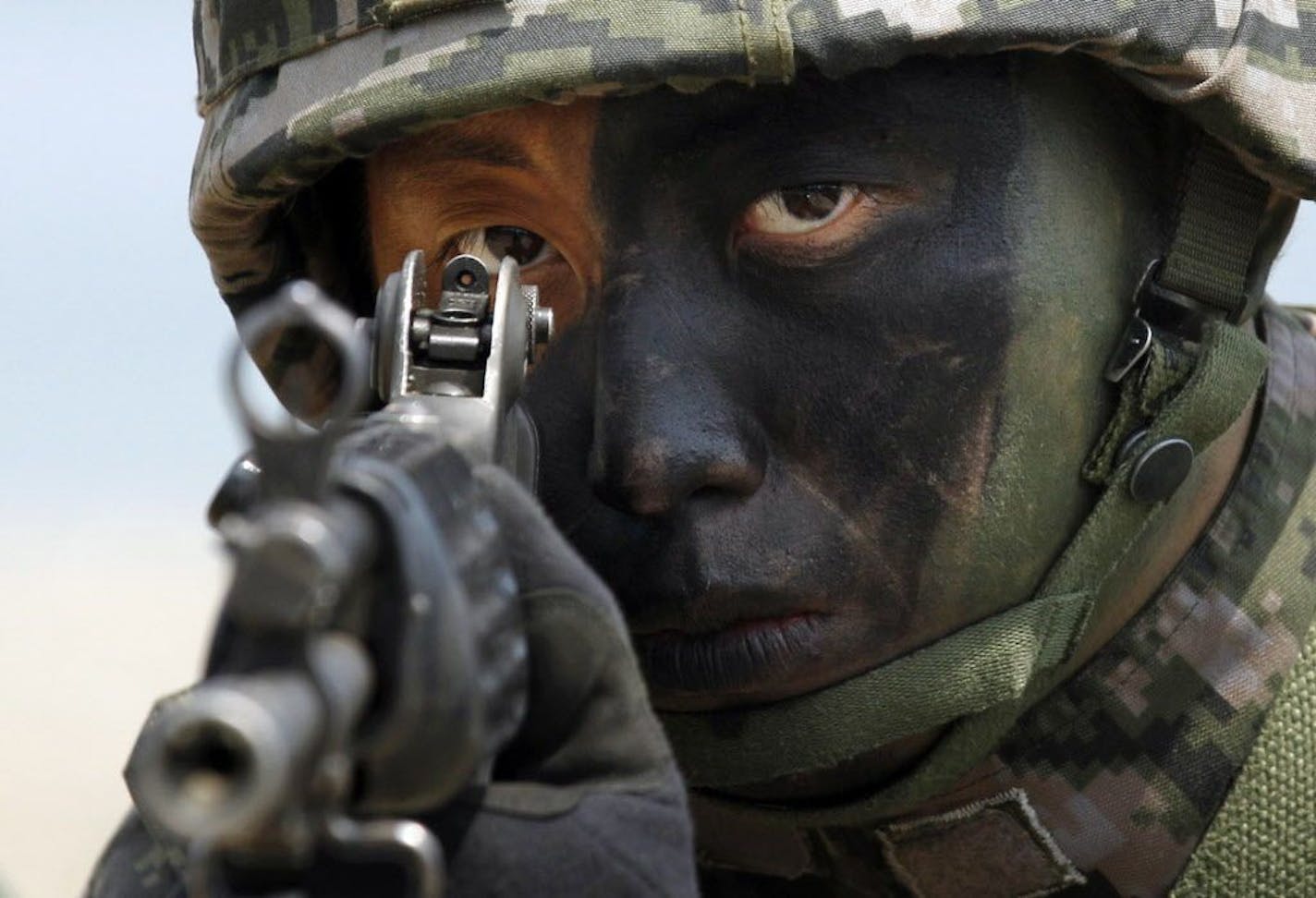 FILE - In this April 26, 2013 file photo, a South Korean Marine takes position during the joint military exercises between South Korea and the United States called Ssangyong 2013 as a part of annual Foal Eagle military exercises in Pohang, south of Seoul, South Korea.