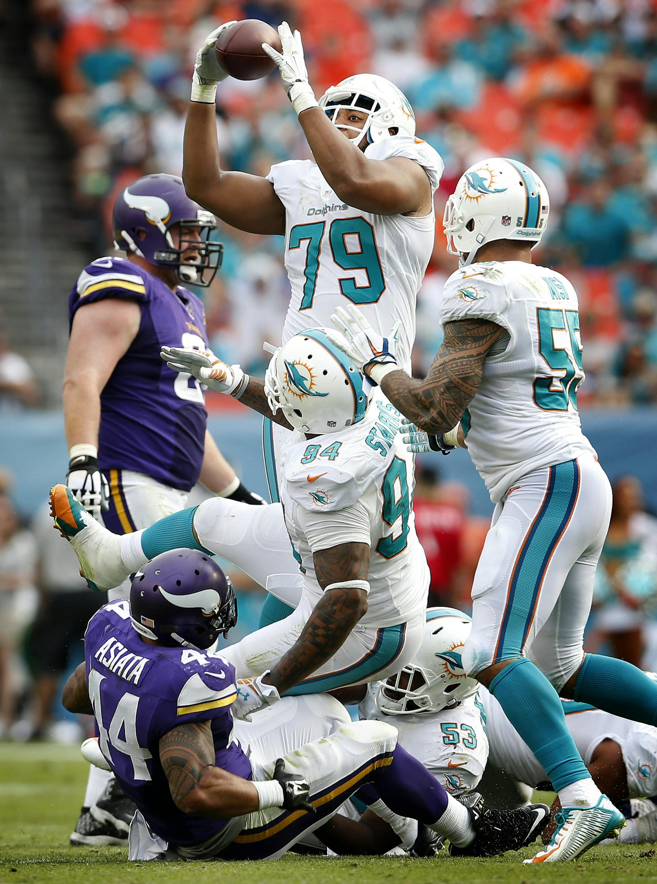 Teddy Bridgewater (5) attempted a pass to Matt Asiata (44) in the third quarter. The pass bounced off of Asiata and was intercepted by Derrick Shelby (79). ] CARLOS GONZALEZ cgonzalez@startribune.com - December 21, 2014, Miami Gardens, FL, Sun Life Stadium, NFL, Minnesota Vikings vs. Miami Dolphins
