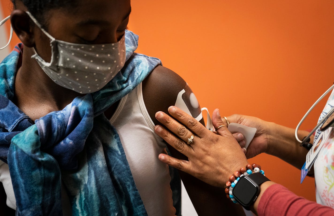 Medical assistant Serena Jackson put a numbing patch on Laila Moses, 12, at the beginning of her well-being appointment before she got a HPV vaccination at Children's MN Partners in Pediatrics in Brooklyn Park, Minn., on Friday, April 9, 2021.