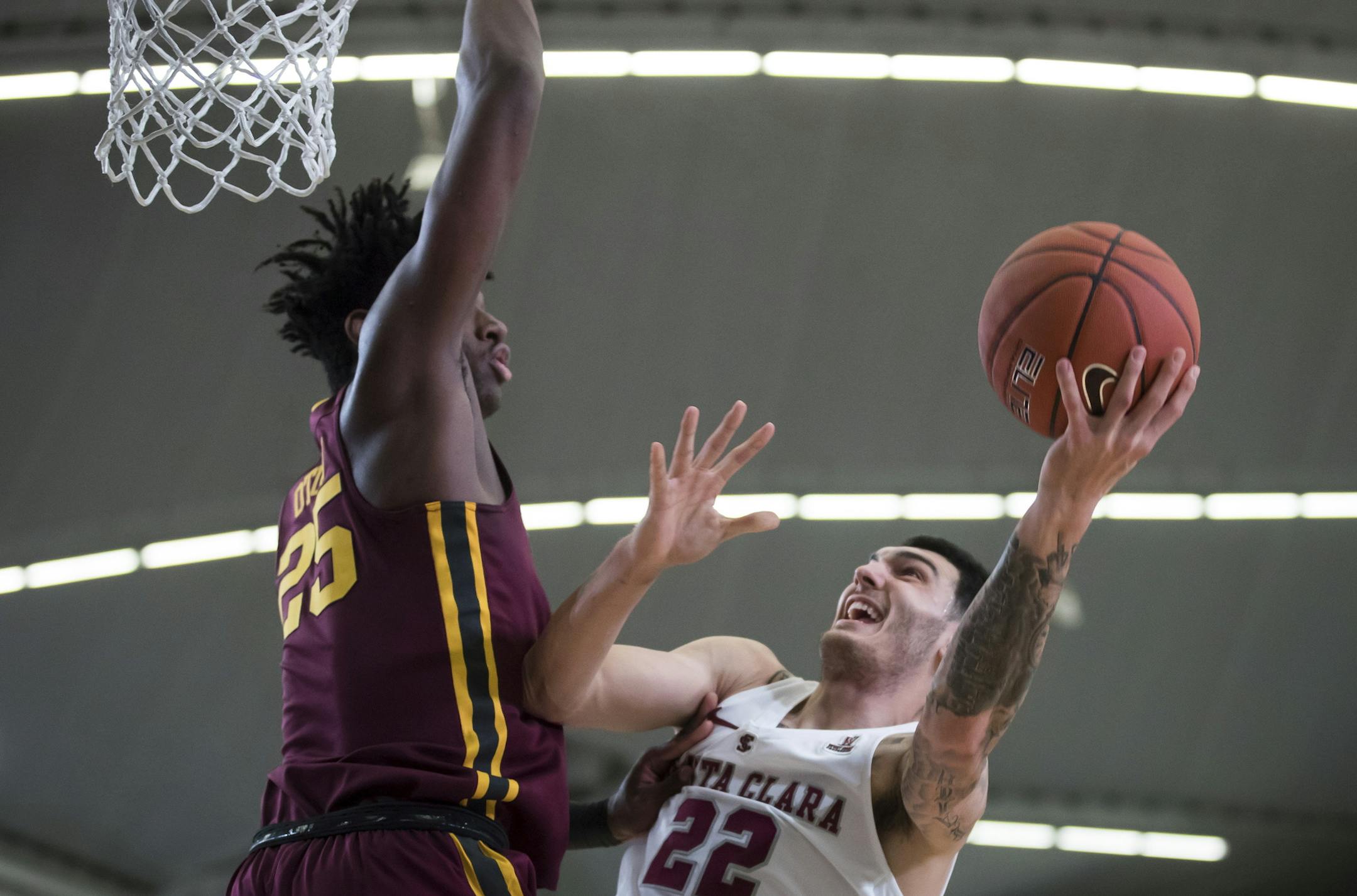 Santa Clara's Josh Martin, right, shoots over Minnesota's Daniel Oturu during the first half of an NCAA college basketball game, Tuesday, Nov. 20, 2018 in Vancouver, British Columbia. (Darryl Dyck/The Canadian Press via AP)
