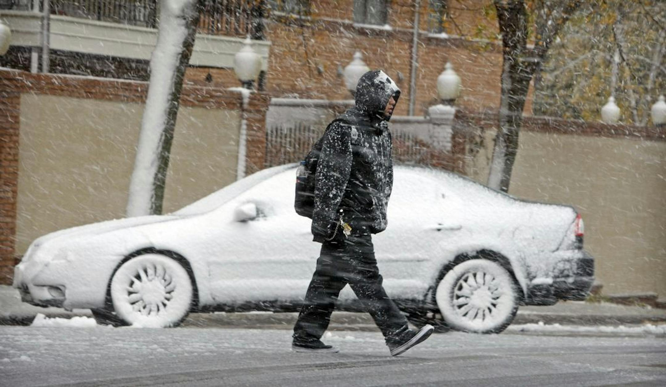 A pedestrian made his way through the snowfall on Thursday in downtown Fargo, N.D.