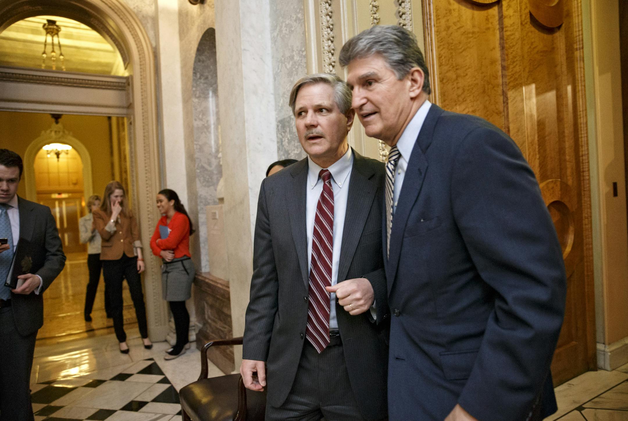 Sen. John Hoeven, R-N.D., sponsor of the Keystone XL pipeline bill, left, and Sen. Joe Manchin, D-W.Va., the Democratic co-sponsor, leave the Senate chamber on Capitol Hill in Washington, Wednesday, March 4, 2015, after the GOP-controlled Senate failed to override President Barack Obama's veto of a bill to construct the Keystone XL pipeline, the first of many confrontations between the Republican-controlled Congress and the White House this year over energy policy. The 62-37 vote is expected to