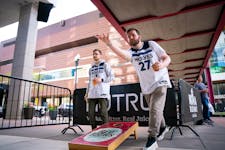 Bobby Erickson throws a beanbag while playing cornhole at Kieran’s Irish Pub before he and his friends head to the Timberwolves game tonight at Targ
