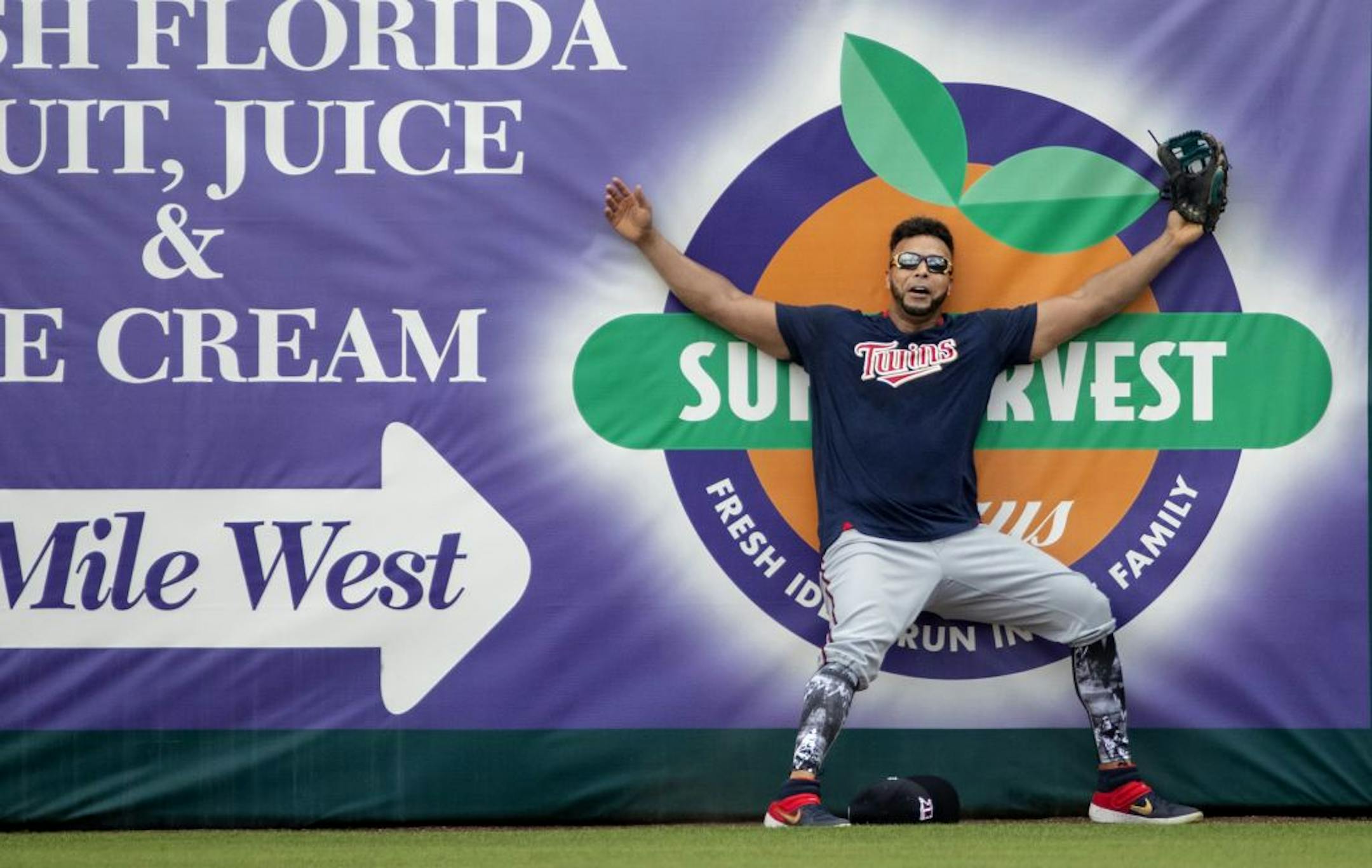Minnesota Twins' Nelson Cruz hit the wall while chasing a fly ball during practice.
