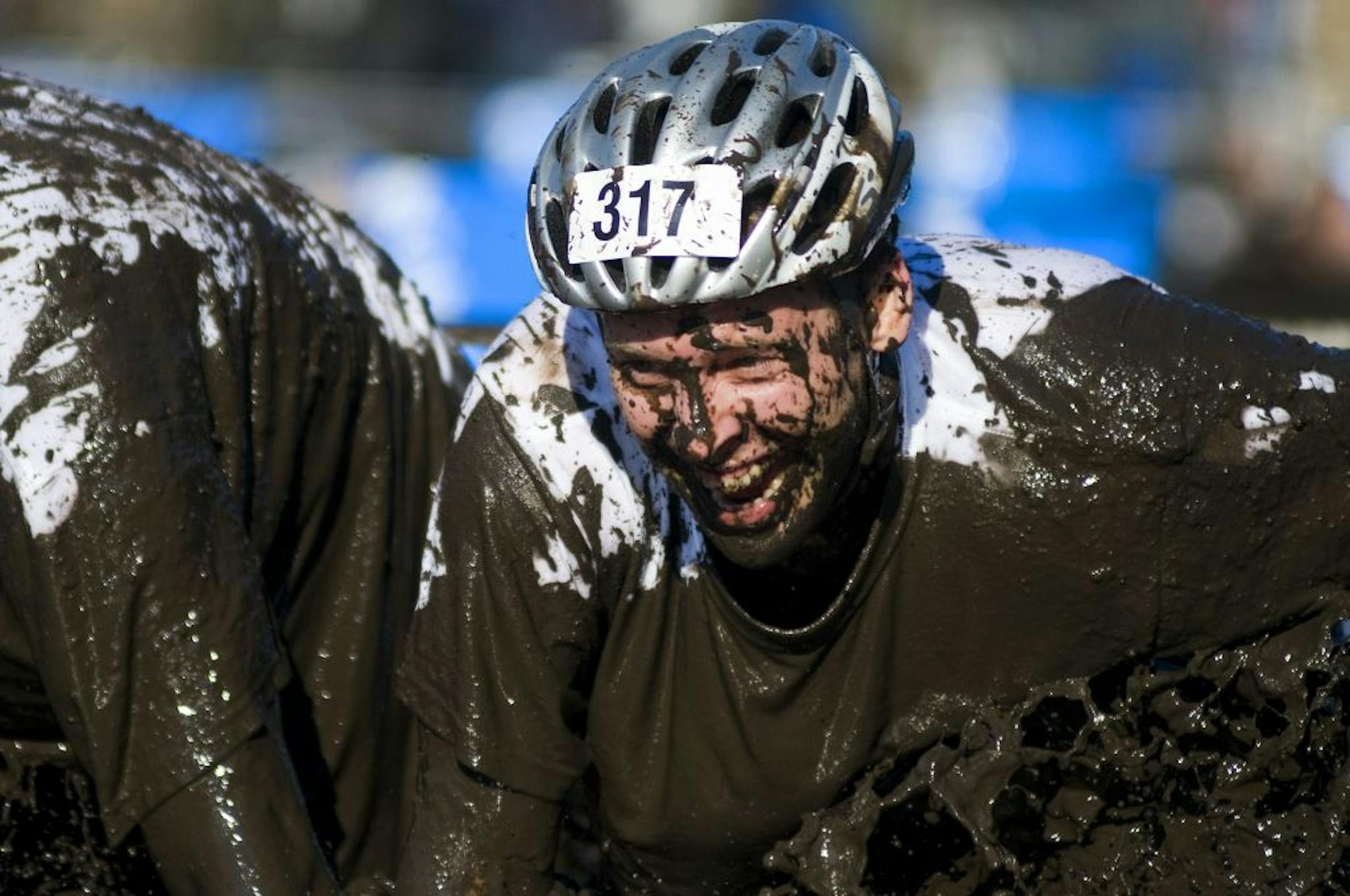 A member from team Grime Time plunges into the mud pit, during the Columbia Muddy Buddy Ride and Run Series on Sunday at the Afton Alps Ski Area in Hastings. More than 2000 people participated in the two-person team running, mountain-biking and a obstacle course competition.