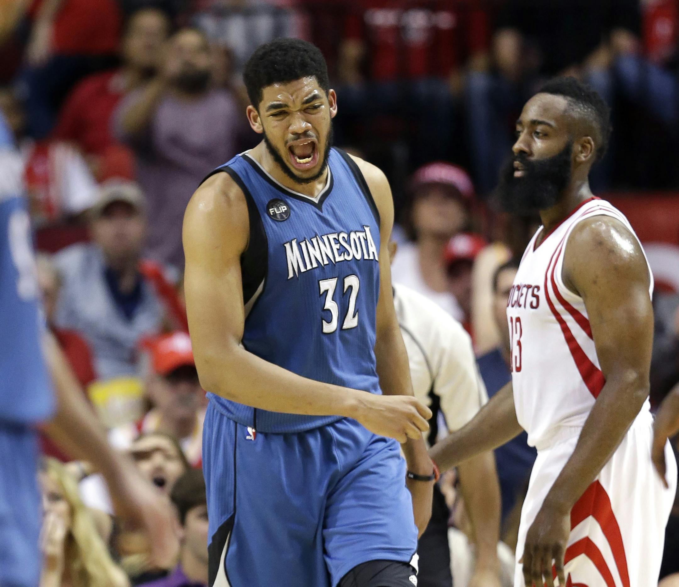 Minnesota Timberwolves' Karl-Anthony Towns (32) reacts after being called for a foul against the Houston Rockets during the second half of an NBA basketball game Friday, March 18, 2016, in Houston. (AP Photo/David J. Phillip)
