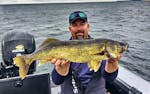 Justin Wathke holds a walleye caught with the help of a forward-facing sonar unit.