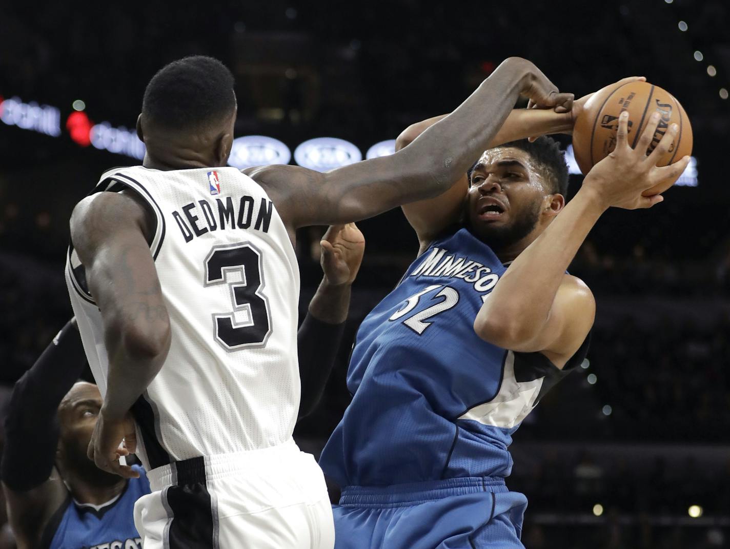 Minnesota Timberwolves center Karl-Anthony Towns (32) is fouled by San Antonio Spurs center Dewayne Dedmon (3) during the first half of an NBA basketball game, Tuesday, Jan. 17, 2017, in San Antonio. (AP Photo/Eric Gay)