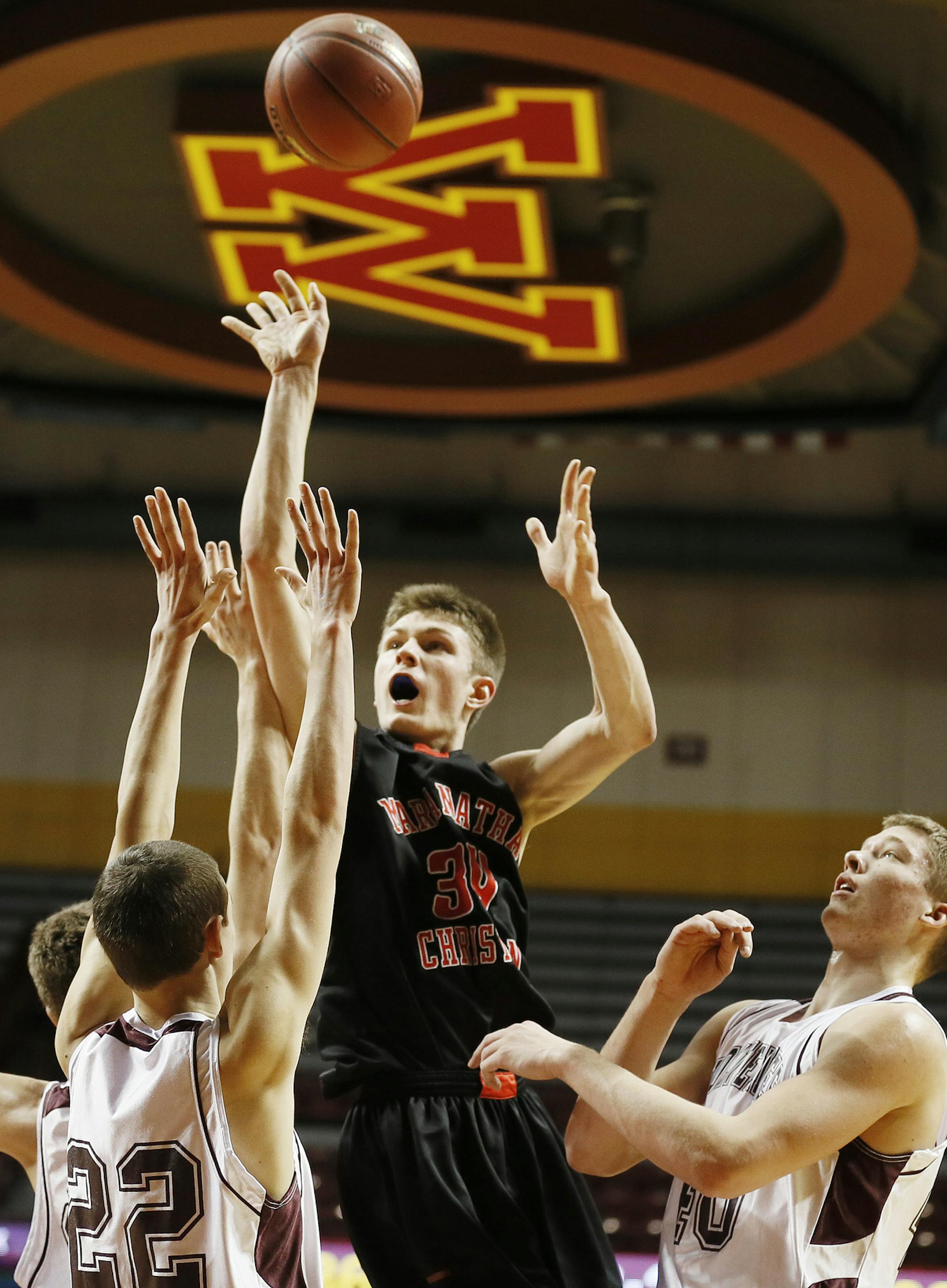 Isaiah Hanson of Maranatha scored two points over Cody Klassen left and Carter Kirk during 1A quarterfinals basketball action between Mountain Lake Area and Maranatha Christian Academy at Williams Arena Thursday March, 21, 2013 in Minneapolis, MN. Maranatha beat Mountain Lake 61-44. ] JERRY HOLT ‚Ä¢ jerry.holt@startribune.com