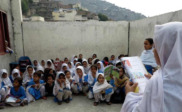 A Pakistani female student reads a chapter during a class in a school in Mingora, capital of Swat Valley, hometown of Malala Yousafzai, in Pakistan, T