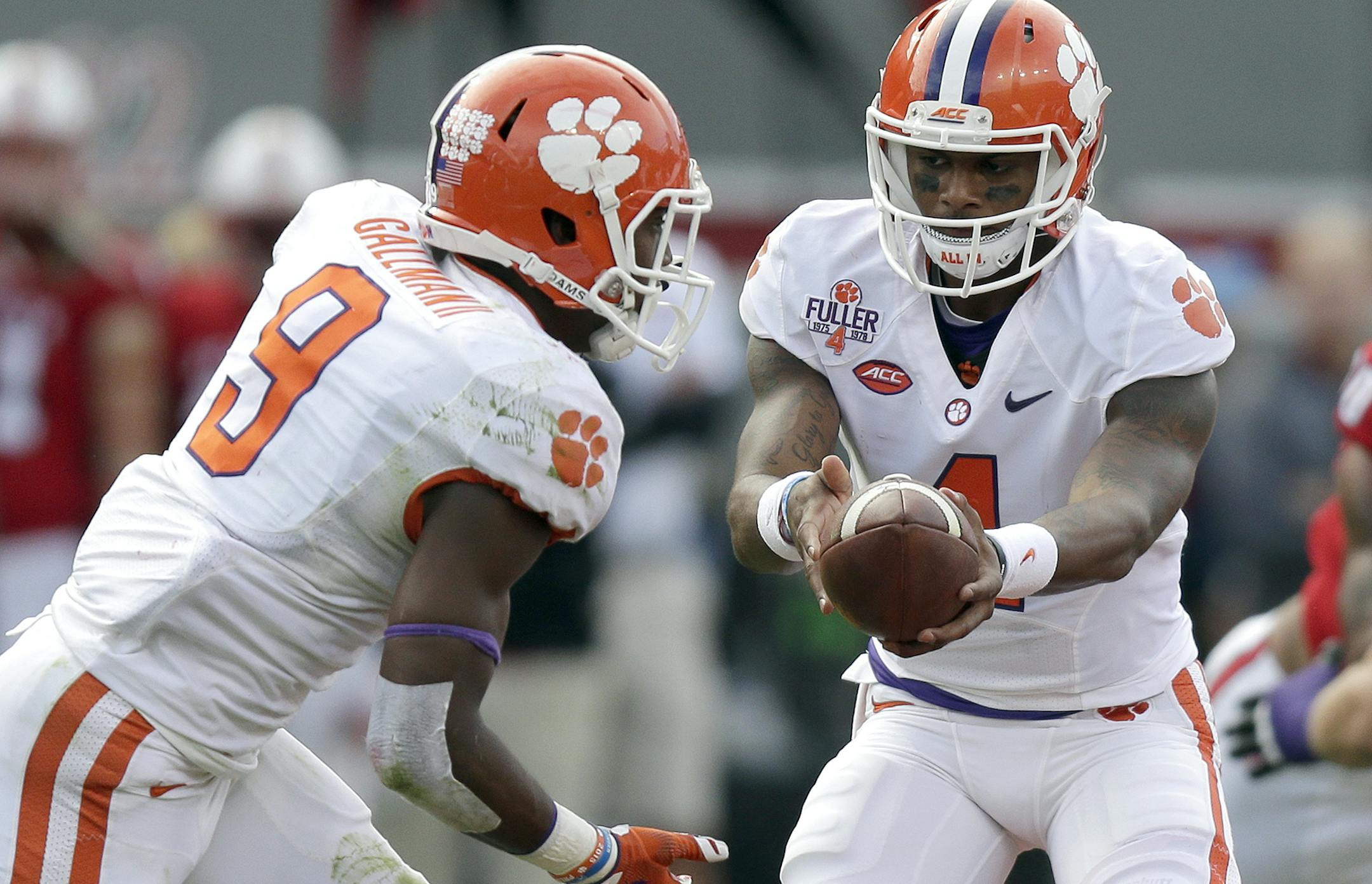 Clemson quarterback Deshaun Watson hands off to Wayne Gallman (9) during the first half of an NCAA college football game against North Carolina State in Raleigh, N.C., Saturday, Oct. 31, 2015. (AP Photo/Gerry Broome)