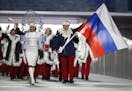 FILE - In this Feb. 7, 2014 file photo Alexander Zubkov of Russia carries the national flag as he leads the team during the opening ceremony of the 20