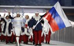 FILE - In this Feb. 7, 2014 file photo Alexander Zubkov of Russia carries the national flag as he leads the team during the opening ceremony of the 20