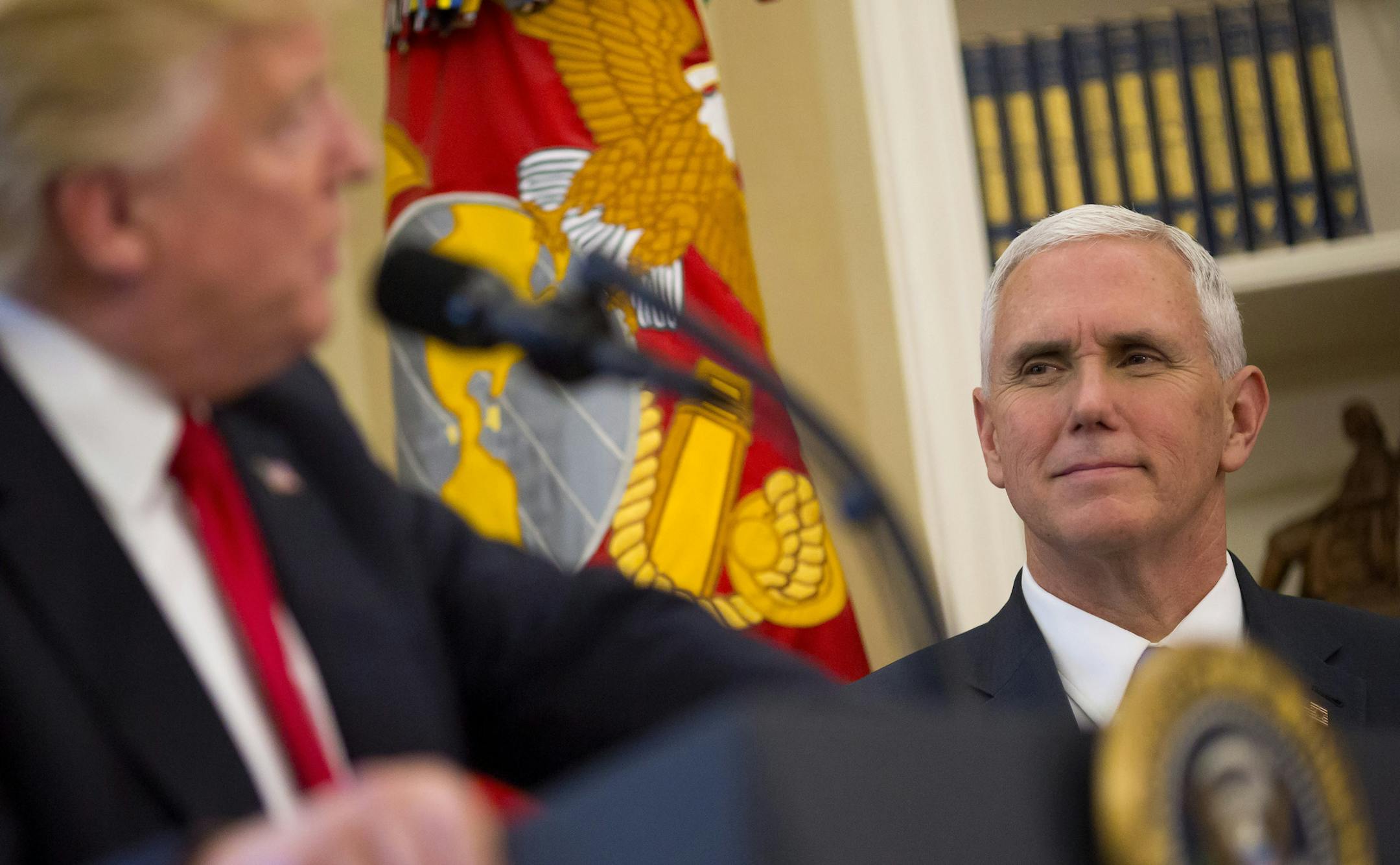 Vice President Mike Pence listens as President Donald Trump spoke before signing executive orders, at the White House in Washington, March 31, 2017. Pence retrieved the orders after Trump left the Oval Office without signing them; a White House official said Trump signed them later. (Eric Thayer/The New York Times)