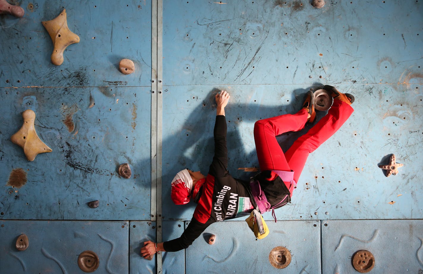 In this Monday, Jan. 18, 2016 photo, Iranian rock climber, Farnaz Esmaeilzadeh, scales a climbing gym in the city of Zanjan, some 330 kilometers (207 miles) west of the capital Tehran, Iran. Esmaeilzadeh, 27, who has been climbing since she was 13, has distinguished herself in international competitions despite the barriers she faces as a female athlete in conservative Iran. (AP Photo/Ebrahim Noroozi)