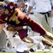 Minnesota's Eric Decker (7) is brought down by Kansas cornerback Kendrick Harper during the first quarter of the Insight Bowl NCAA college football ga
