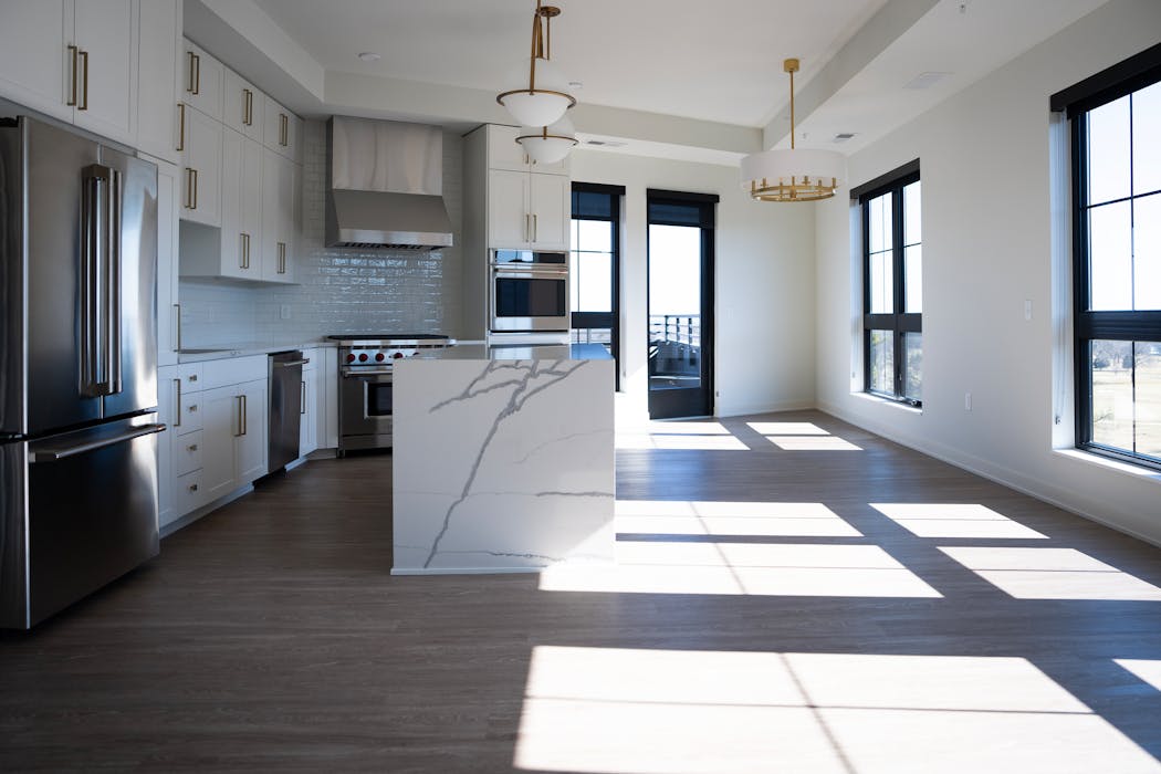 Natural light fills the kitchen inside a penthouse suite at Maison Green in Edina.