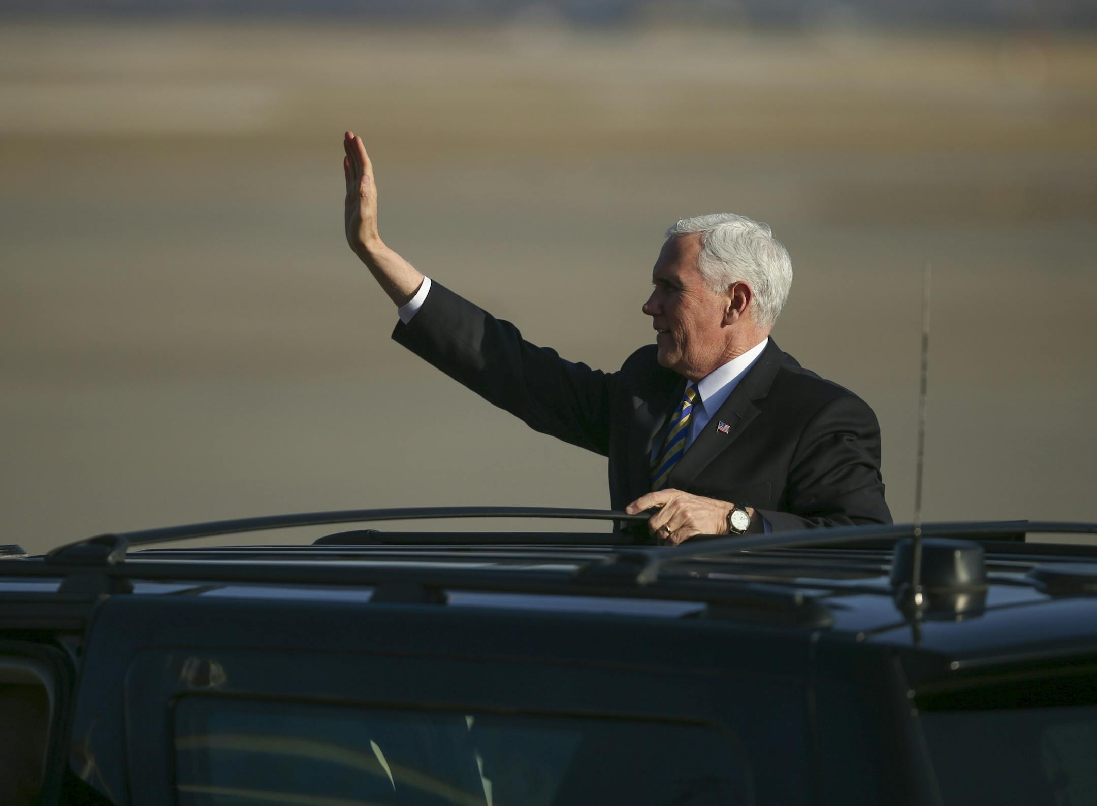 Vice President Mike Pence stood on the running board of his limo to wave goodbye to the supporters who welcomed him after his arrival at Minnesota National Guard - 934th Airlift Wing.