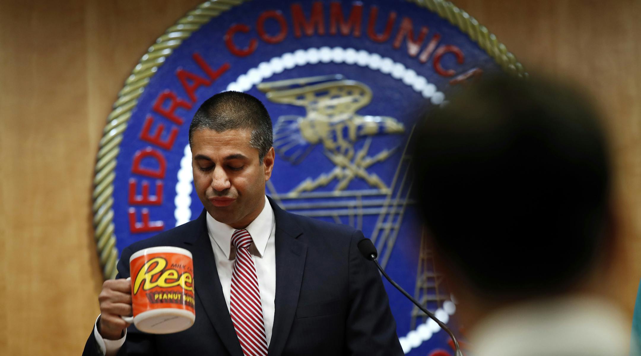 After a meeting voting to end net neutrality, Federal Communications Commission (FCC) Chairman Ajit Pai, takes a sip from his mug while answering questions from the media, Thursday, Dec. 14, 2017, in Washington. (AP Photo/Jacquelyn Martin)