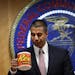After a meeting voting to end net neutrality, Federal Communications Commission (FCC) Chairman Ajit Pai, takes a sip from his mug while answering ques