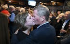 Tim Busse and his wife, Heather, shared a celebratory kiss Tuesday night in Bloomington after Tim Busse was elected mayor.