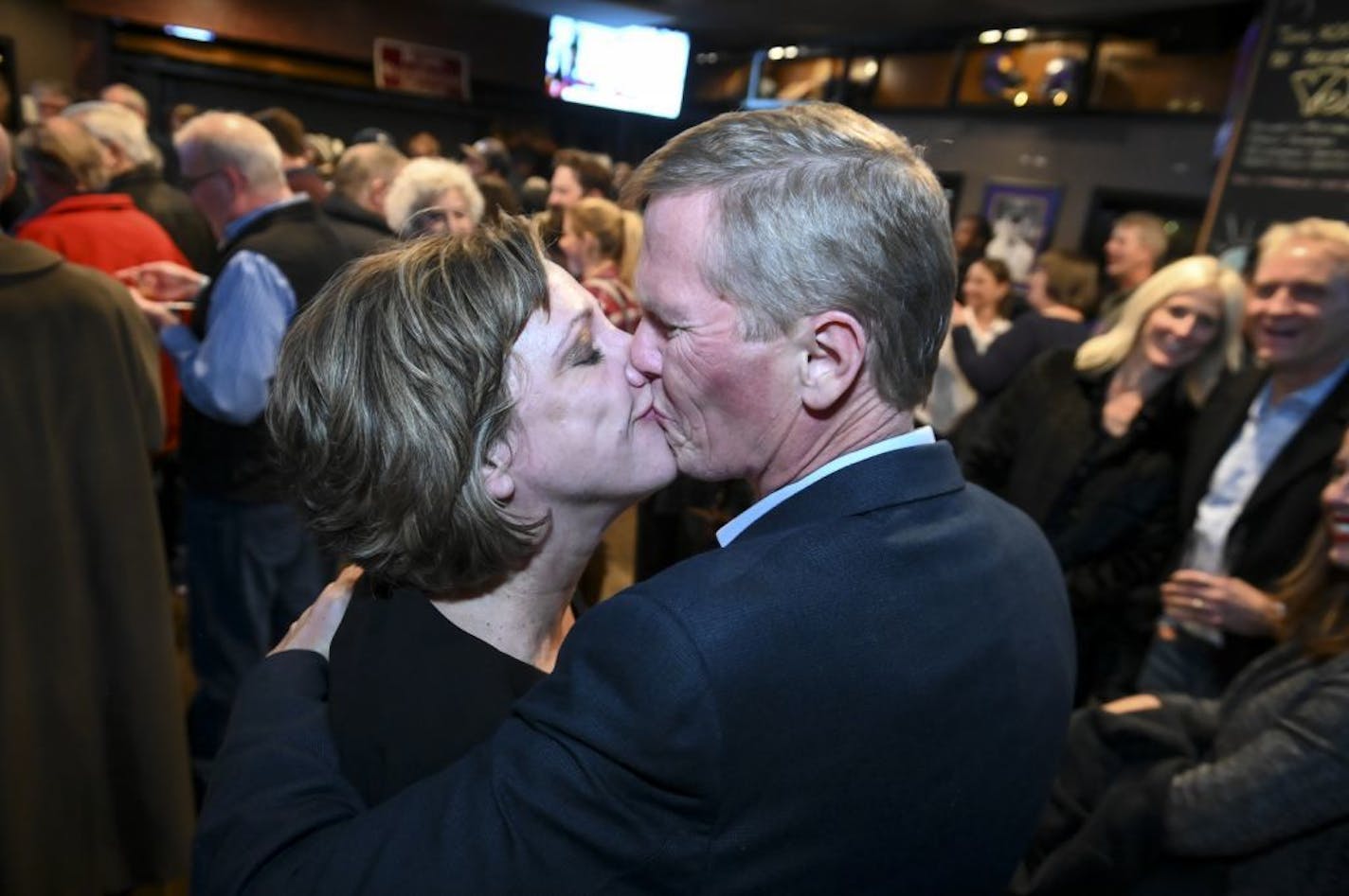 Tim Busse and his wife, Heather, shared a celebratory kiss Tuesday night in Bloomington after Tim Busse was elected mayor.