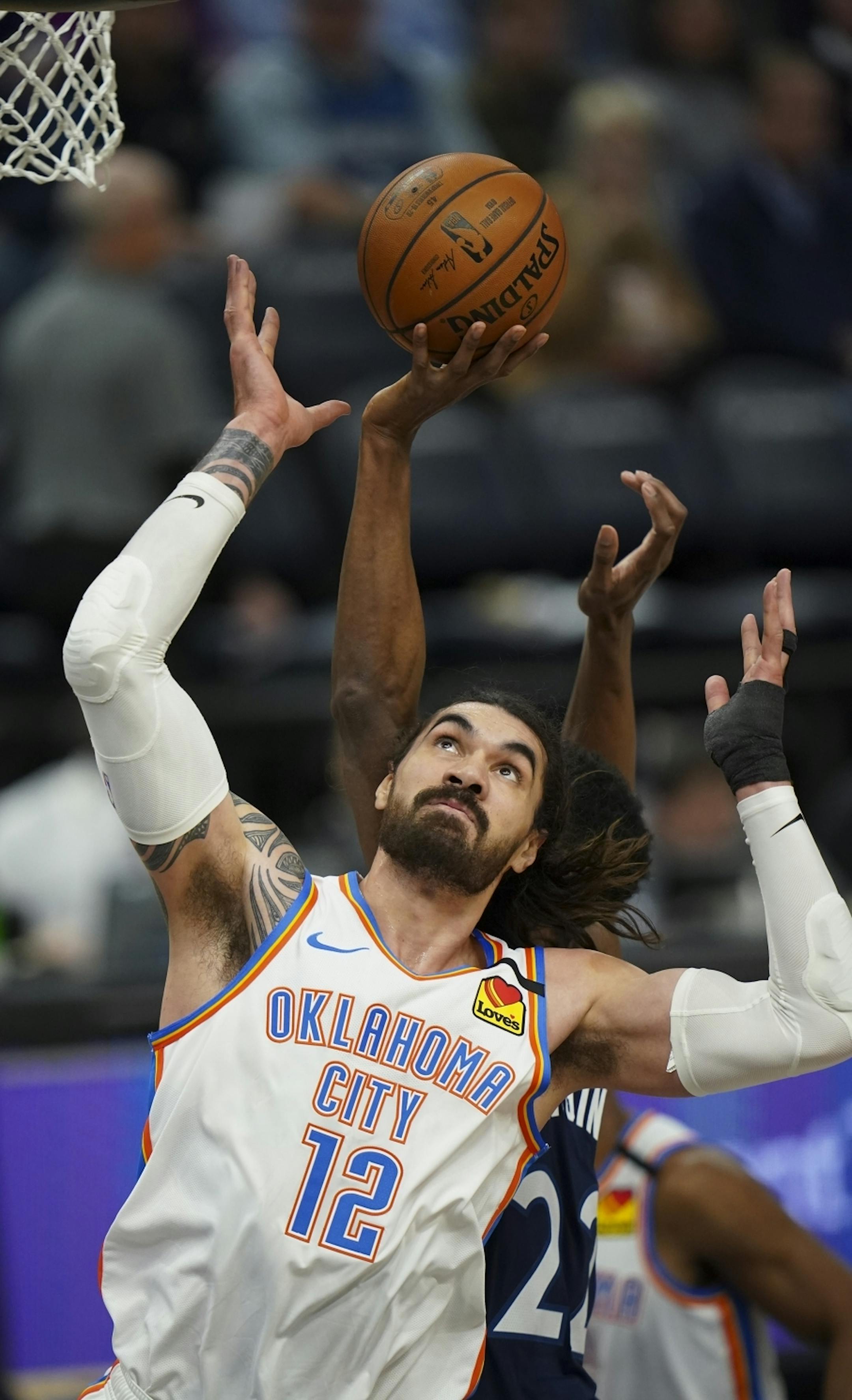 Minnesota Timberwolves forward Andrew Wiggins (22) tried to put up a third quarter shot while Oklahoma City Thunder center Steven Adams (12) defended. Wiggins finished with 10 points.