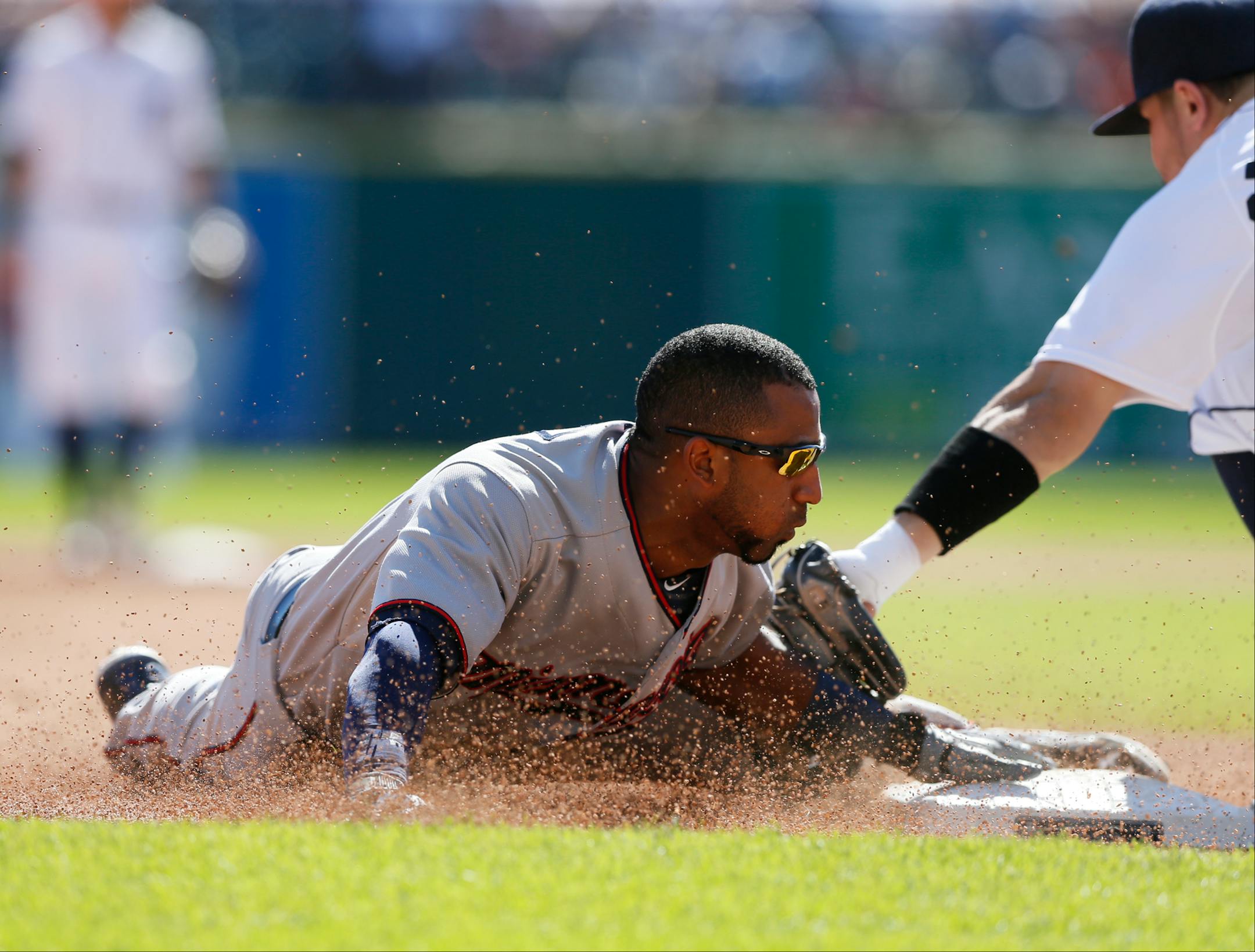 Minnesota Twins' Eduardo Nunez beats the tag of Detroit Tigers' 'Nick Castellanos as he steals third base during the fifth inning on Sunday, Sept. 27, 2015, at Comerica Park in Detroit.