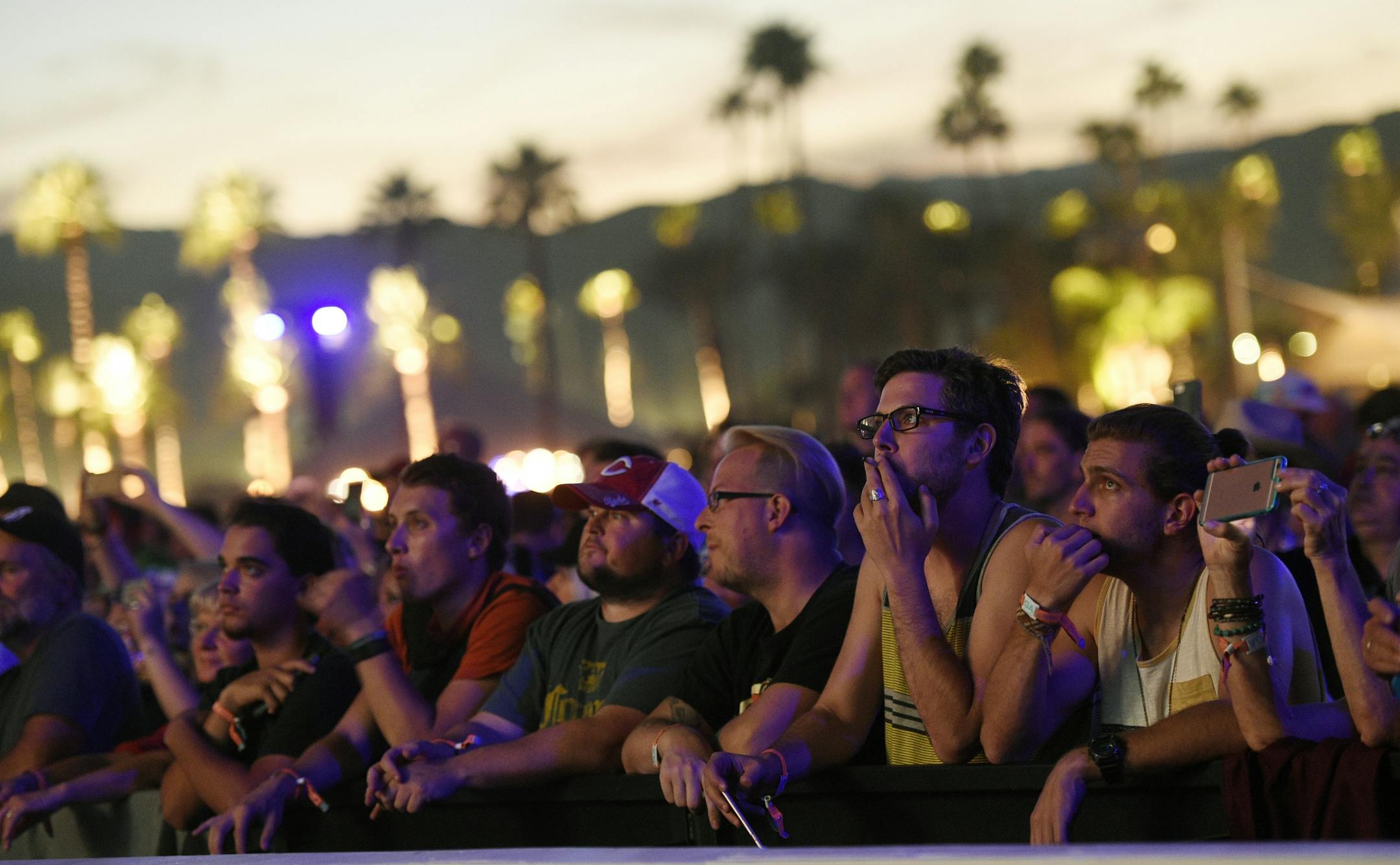 Festival goers watch Neil Young's performance on day 2 of the 2016 Desert Trip music festival at Empire Polo Field on Saturday, Oct. 8, 2016, in Indio, Calif.