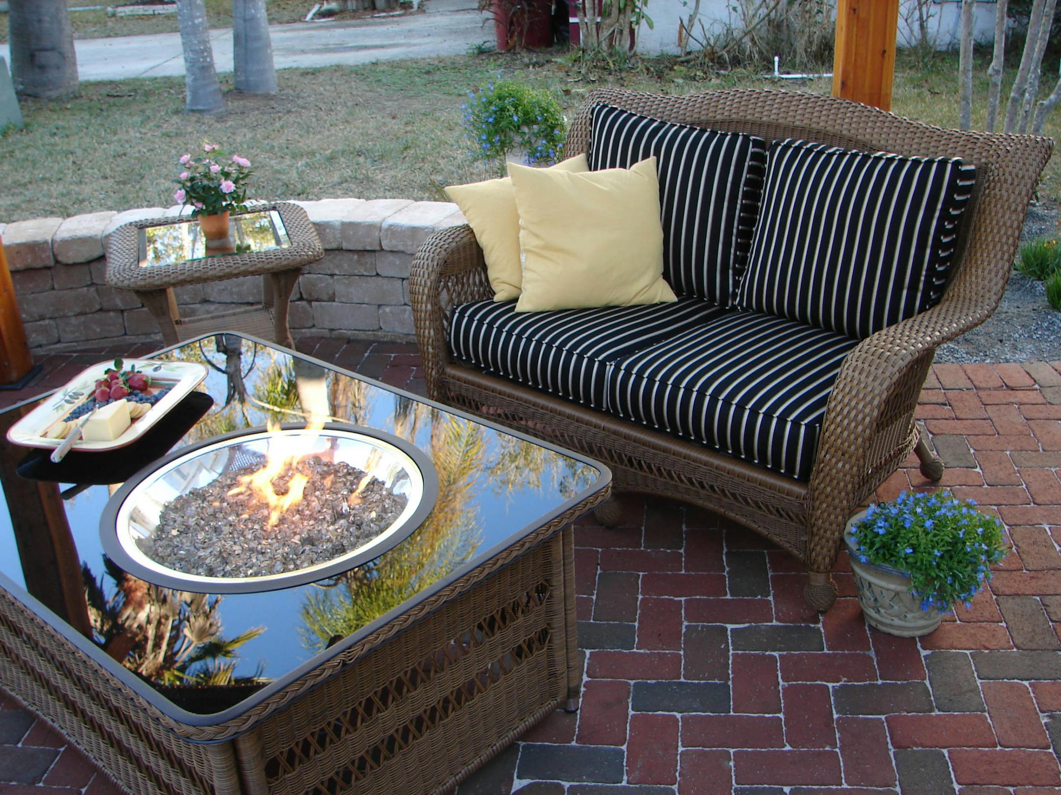SH13E076FIREPITS May 13, 2013 --Fire pits have become upscale, made to match any patio furniture with such features as automatic ignition and a propane tank hidden in a pull-out drawer. (SHNS photo courtesy Scripps Networks Interactive)