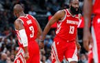 Houston Rockets guard Chris Paul, left, congratulates Houston Rockets guard James Harden after his basket against the Denver Nuggets in the second hal