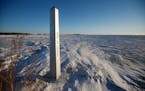 FILE - A border marker, between the United States and Canada is shown just outside of Emerson, Manitoba, on Jan. 20, 2022.