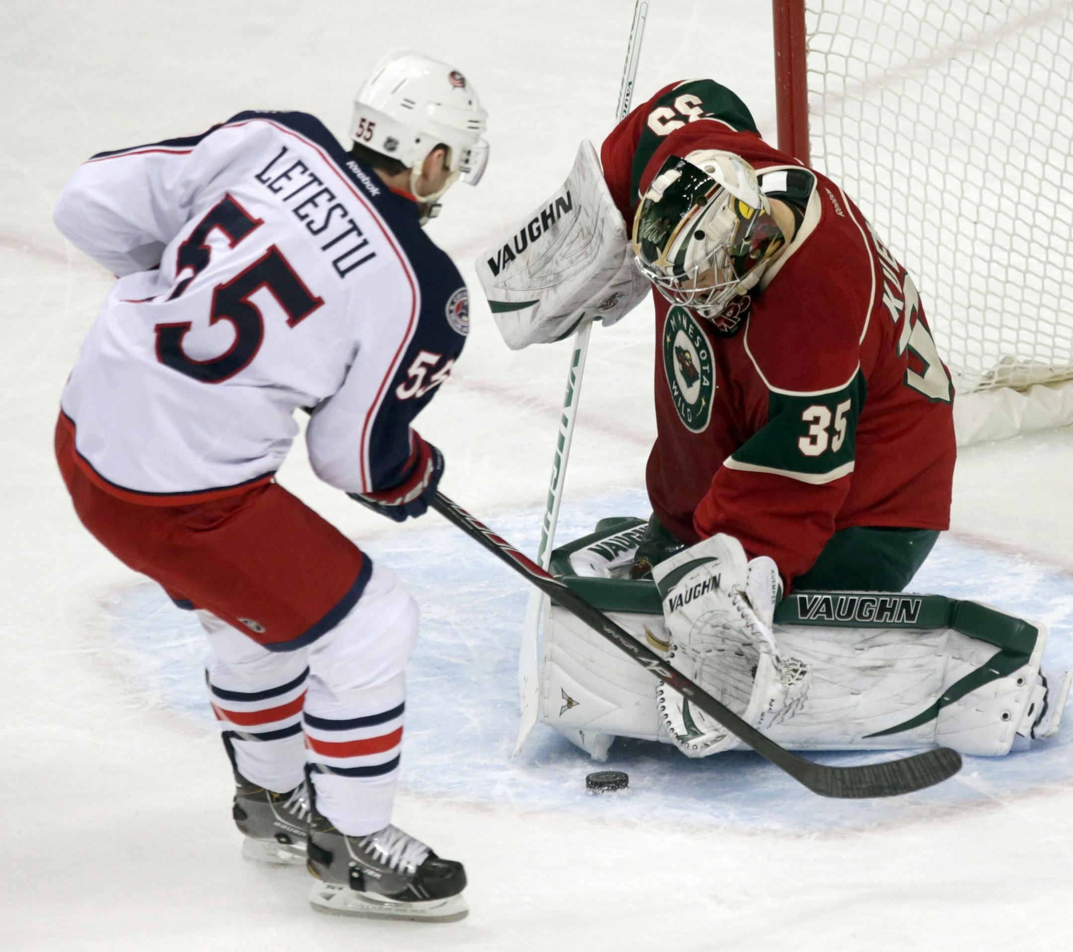 Minnesota Wild goalie Darcy Kuemper, right, stops a shot by Columbus Blue Jackets' Mark Letestu in the first period of an NHL hockey game, Saturday, March 15, 2014, in St. Paul, Minn. (AP Photo/Jim Mone)
