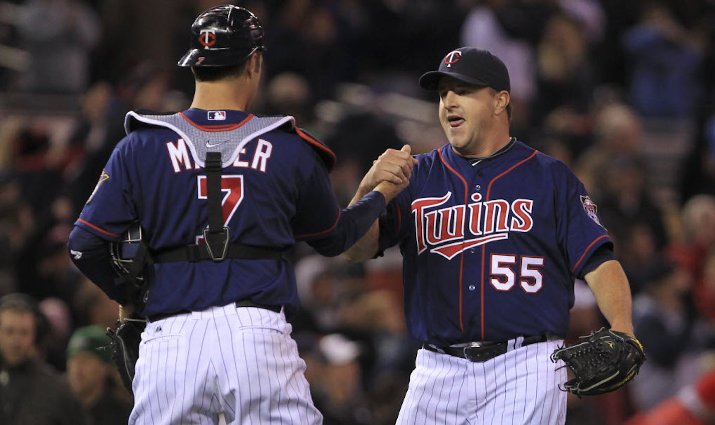 Closer Matt Capps and catcher Joe Mauer celebrated the Twins first win Wednesday, a 6-5 victory over the Angels.