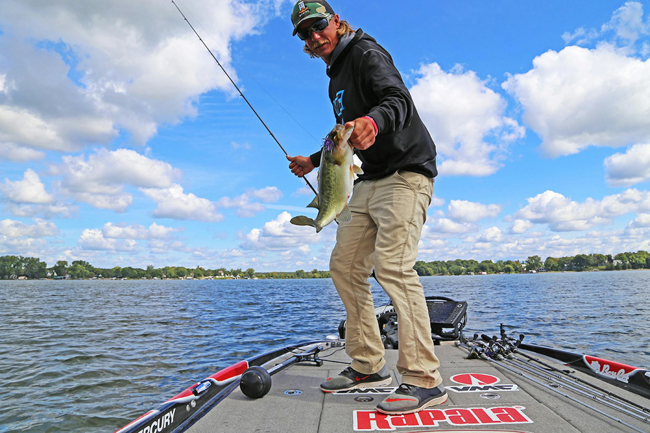 Seth Feider with a plump largemouth bass caught while practice fishing on Lake Minnetonka in advance of the big Bassmaster tournament on Lake Mille Lacs.