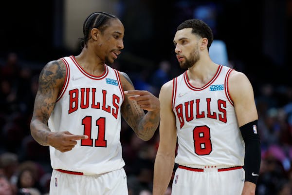 Chicago Bulls' DeMar DeRozan (11) and Zach LaVine (8) talk during the second half of an NBA basketball game against the Cleveland Cavaliers, Saturday,
