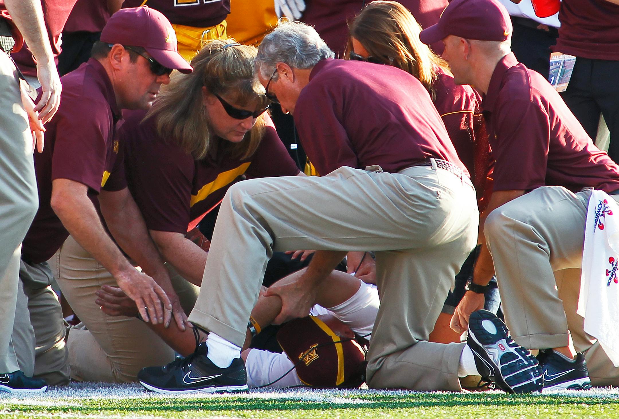 Medical personnel attend to Minnesota head coach Jerry Kill after he suffered a seizure on the sidelines with 20 seconds left in the game against New Mexico State in 2011.