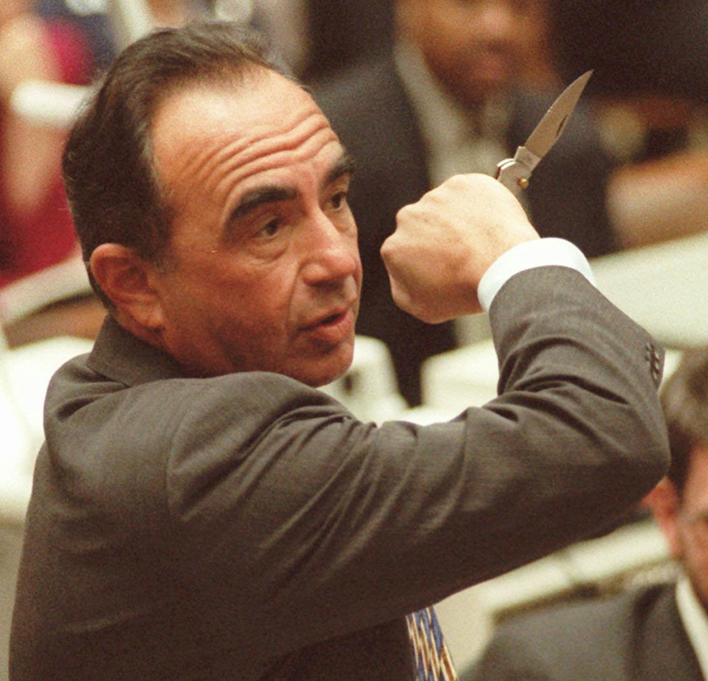 Defense attorney Robert Shapiro wields a knife during the morning session Thursday, June 15, 1995, of the O.J. Simpson double-murder trial in Los Angeles. During cross-examination of Los Angeles County Coroner Dr. Lakshmanan Sathyavagiswaran, Shapiro was demonstrating the many ways a knife could be handled. Prosecuting attorney Brian Kelberg is in background.(AP Photo/Sam Mircovich,Pool) ORG XMIT: LA104