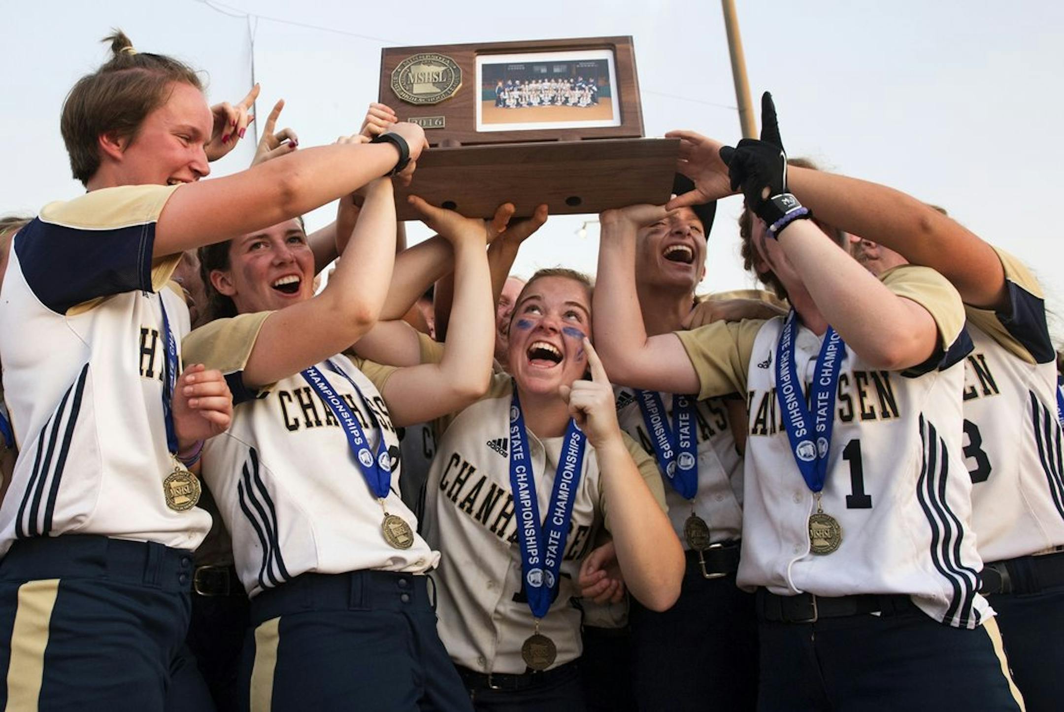 Marybeth Olson gestured victoriously from below the championship trophy while helping teammates celebrate their Class 4A title victory over Buffalo. Olson, normally a shortstop, pitched the final inning after not having pitched for nearly a month because of an injury.