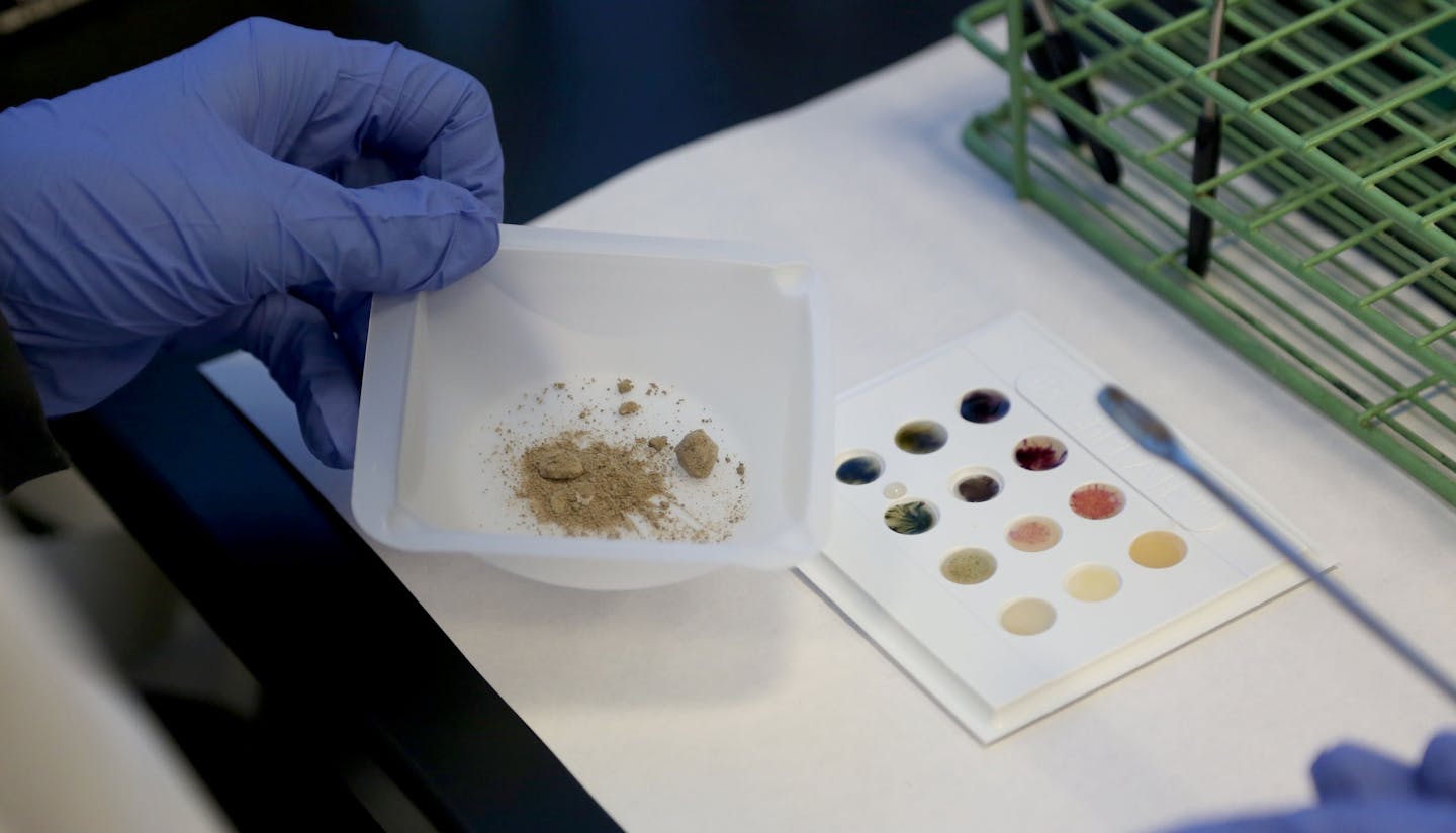 In the drug lab, Amanda Caron, performed a color test on heroin. ] (KYNDELL HARKNESS/STAR TRIBUNE) kyndell.harkness@startribune.com The crime lab at the Anoka County Sheriff's office in Andover , Min., Tuesday August 25, 2015.