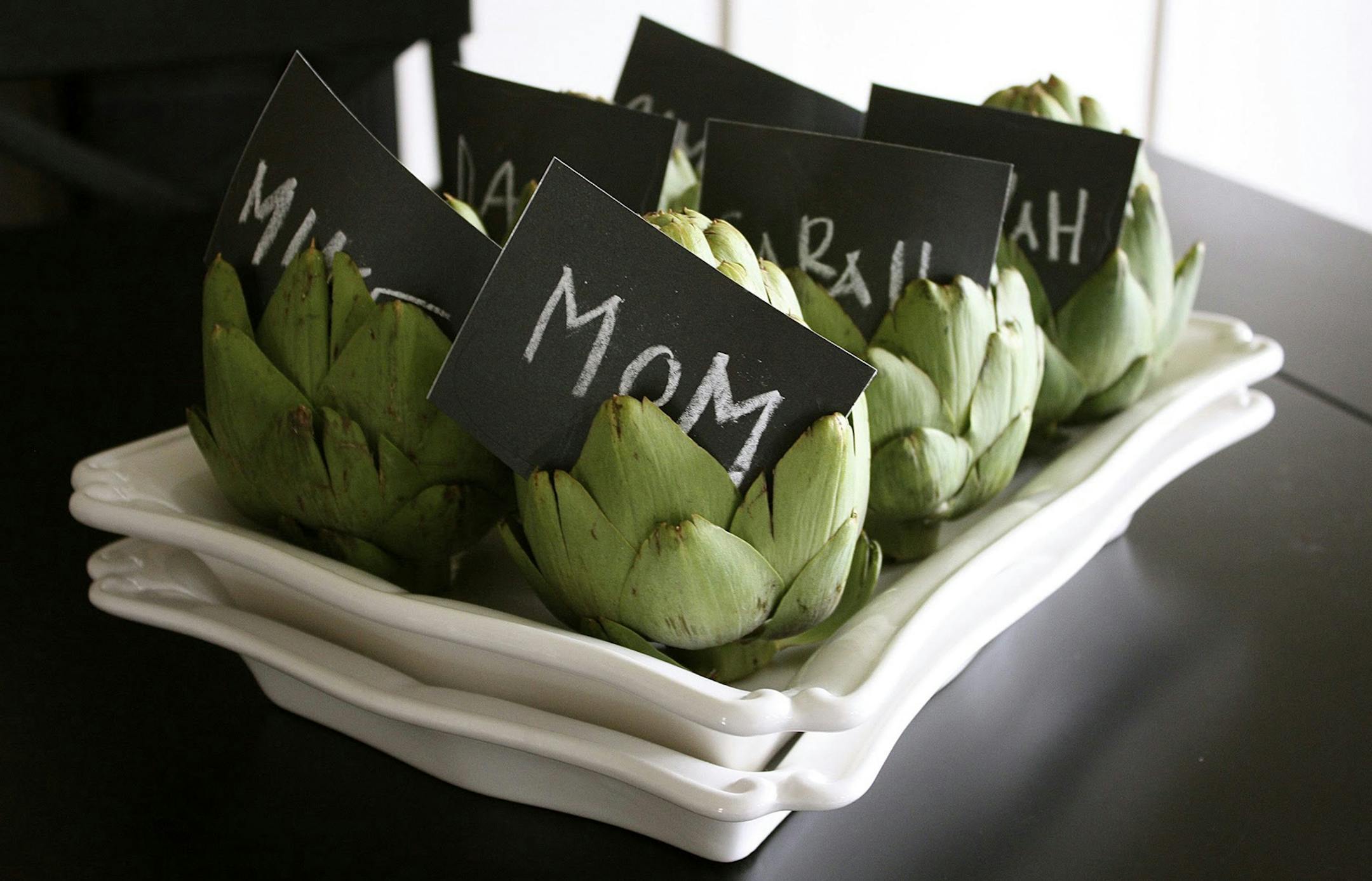 During a recent holiday event, Sarah Macklem, creator of The Yellow Cape Cod design studio and blog, used fresh artichokes to hold place cards made from chalkboard labels she found at a local office supply store. The outcome? A unique, inexpensive (and partially reusable) way to make the evening memorable for her guests. (MCT) ORG XMIT: 1158130