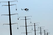 Xcel Energy said it will begin seeking a three-year rate hike of nearly 10 percent from Minnesota customers. File photo of new Xcel power lines under 