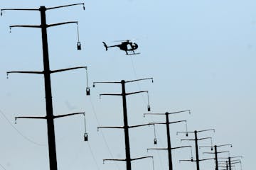 Xcel Energy said it will begin seeking a three-year rate hike of nearly 10 percent from Minnesota customers. File photo of new Xcel power lines under 