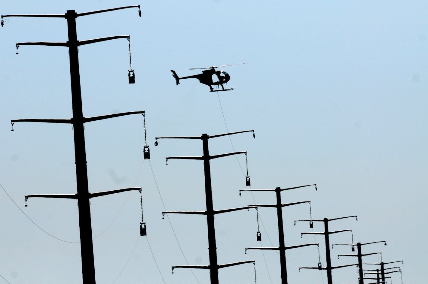 Xcel Energy said it will begin seeking a three-year rate hike of nearly 10 percent from Minnesota customers. File photo of new Xcel power lines under construction in central Minnesota.