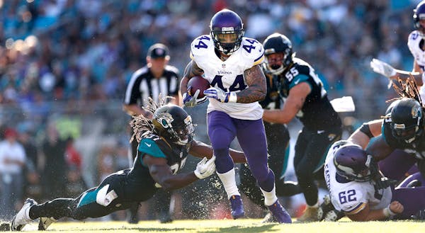 Minnesota Vikings running back Matt Asiata (44) broke a tackle attempt by Jaguars Johnathan Cyprien in the forth quarter picking up a first down at Ev