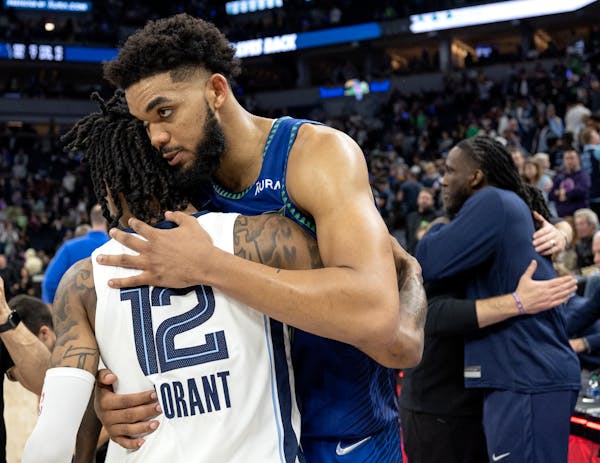 Ja Morant (12) of the Memphis Grizzlies and Karl Anthony-Towns (32) of the Minnesota Timberwolves greet each other at the end of game 6.